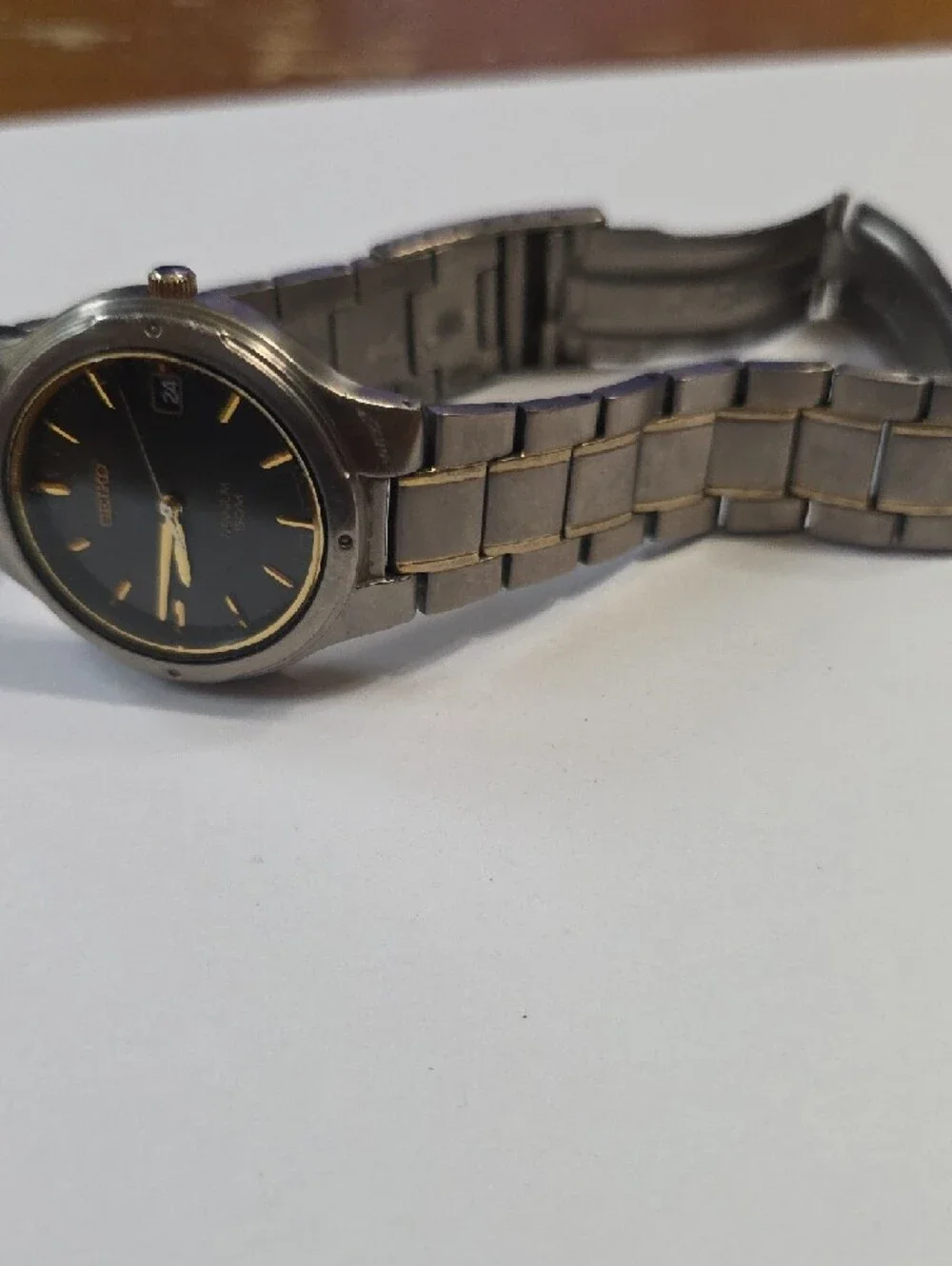 Seiko Titanium Watch with Black Dial and Gold Accents